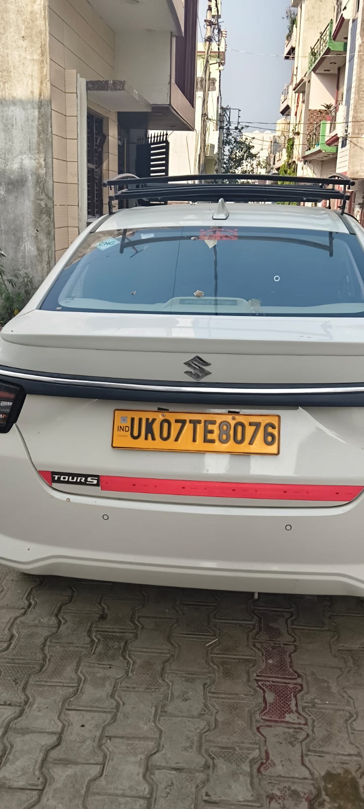 Shree Ji Travels white sedan taxi, full rear photo